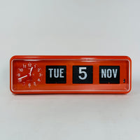 Retro orange analog clock with clock face and vintage mechanical flip date, mid-century modern desk or wall clock