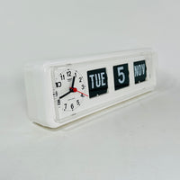 Retro white analog clock with clock face and vintage mechanical flip date, mid-century modern desk or wall clock